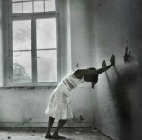 depressed girl leaning on wall