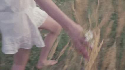 girl running throuh wildflowers